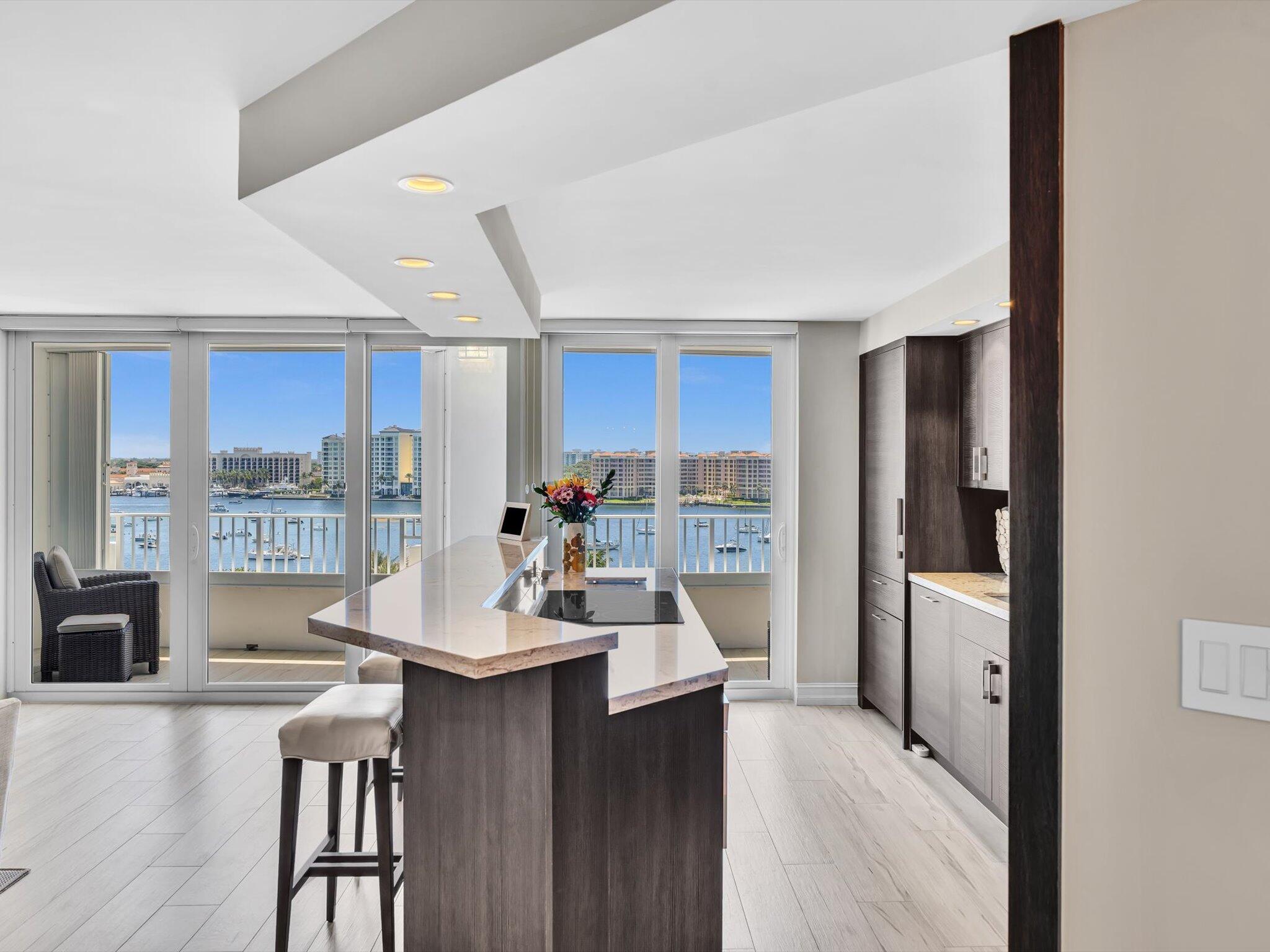 500 South Ocean Boulevard, Unit 909 Boca Raton, FL 33432 - Photo 17 of 101 a kitchen with stainless steel appliances wooden floor and refrigerator