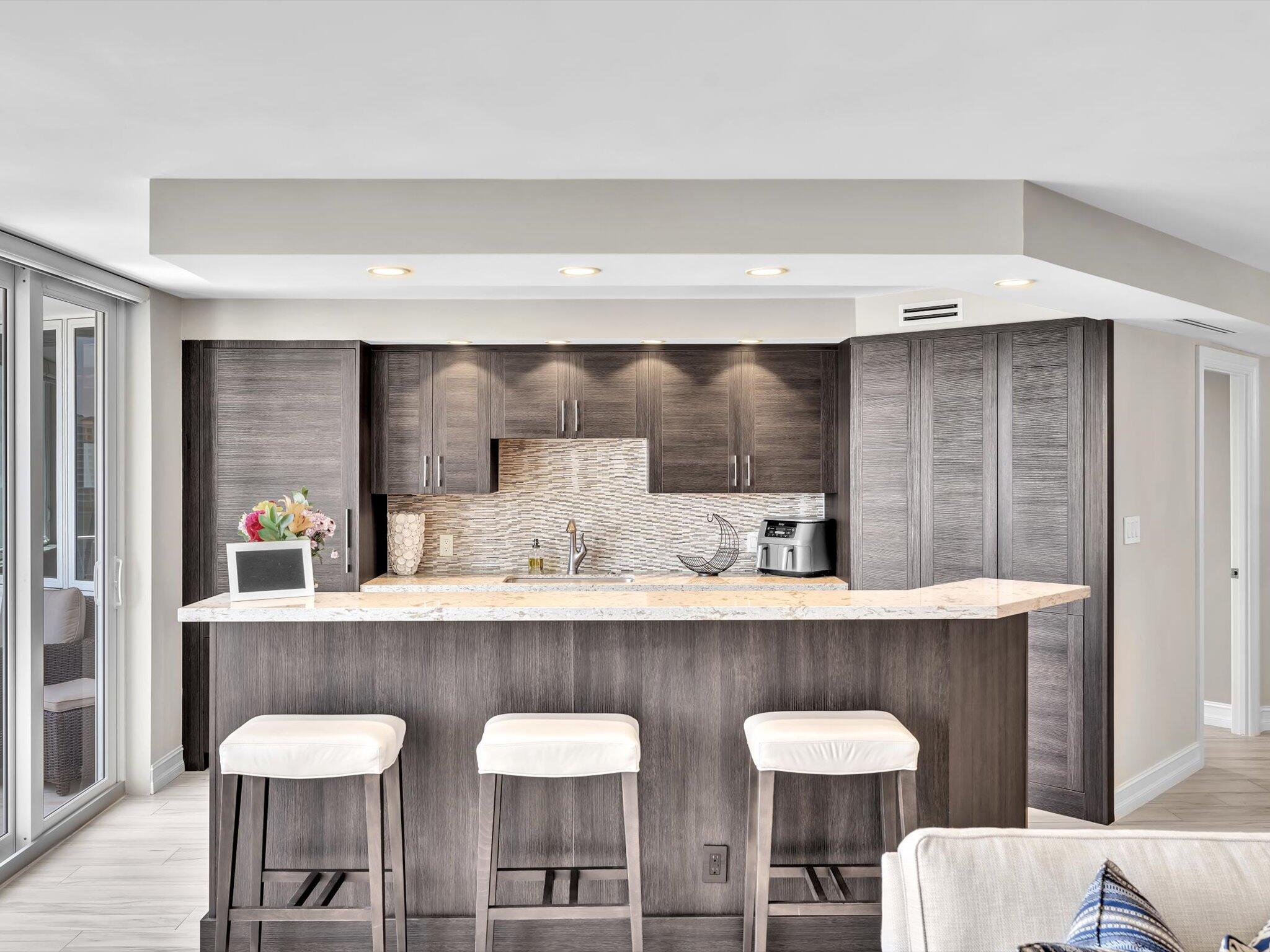 500 South Ocean Boulevard, Unit 909 Boca Raton, FL 33432 - Photo 20 of 101 a kitchen with a table and chairs in it