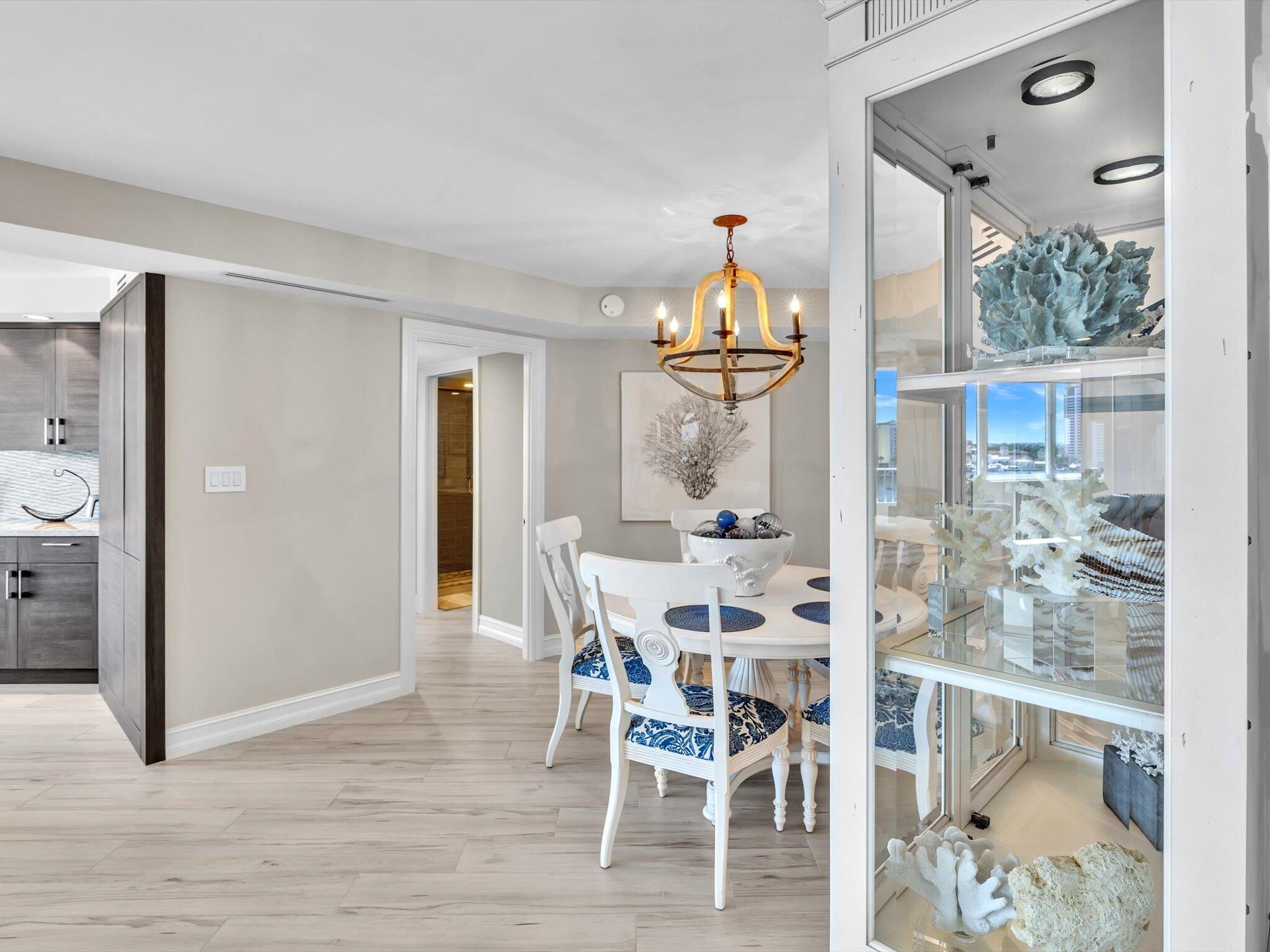 500 South Ocean Boulevard, Unit 909 Boca Raton, FL 33432 - Photo 24 of 101 a view of a dining room with furniture and wooden floor