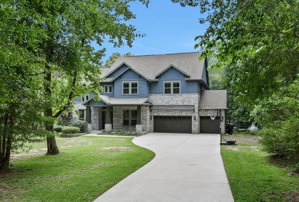 a front view of house with yard and green space