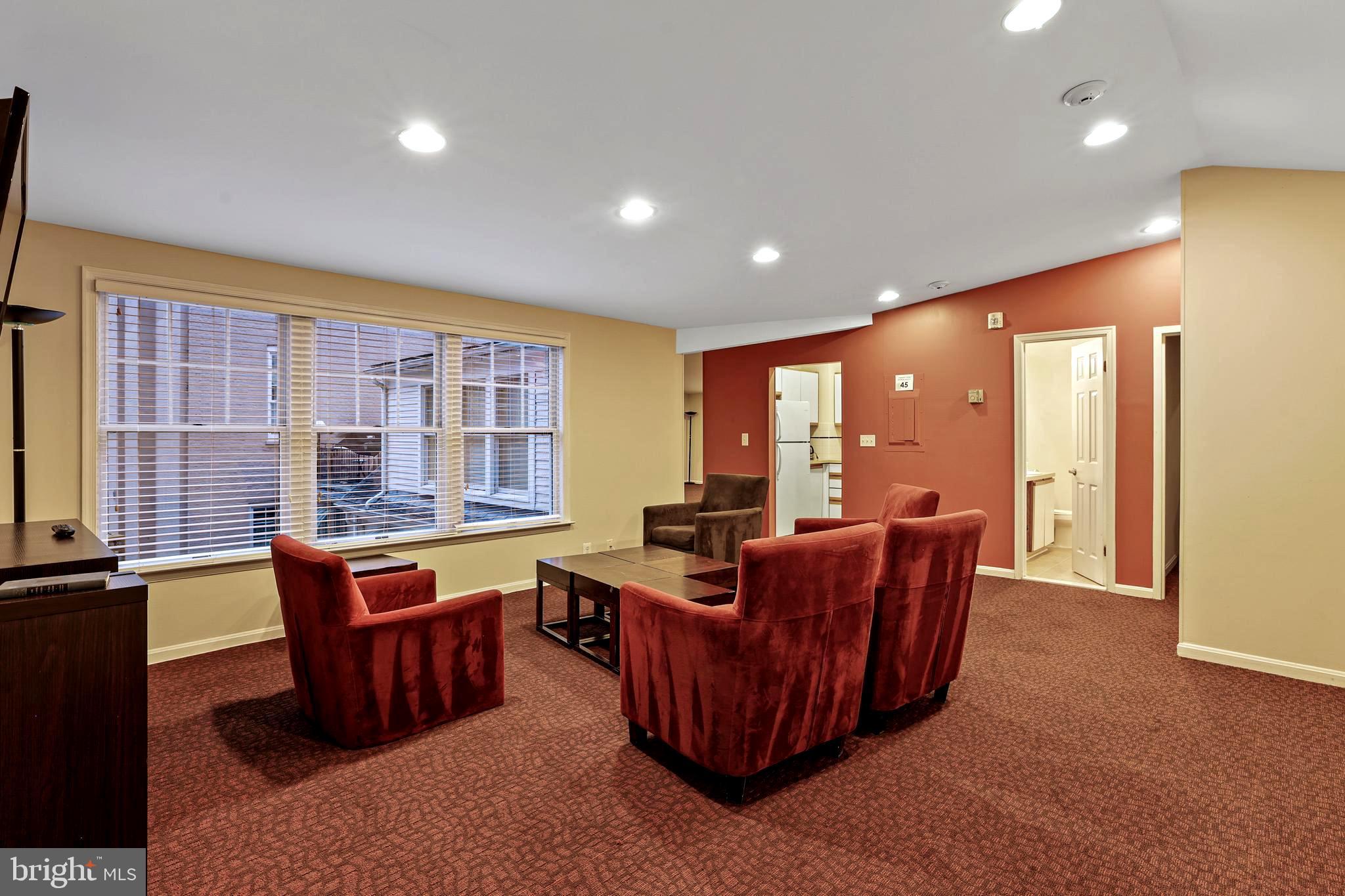 1245 4th Street Southwest, Unit E106 Washington, DC 20024 - Photo 28 of 33 a living room with furniture and large windows