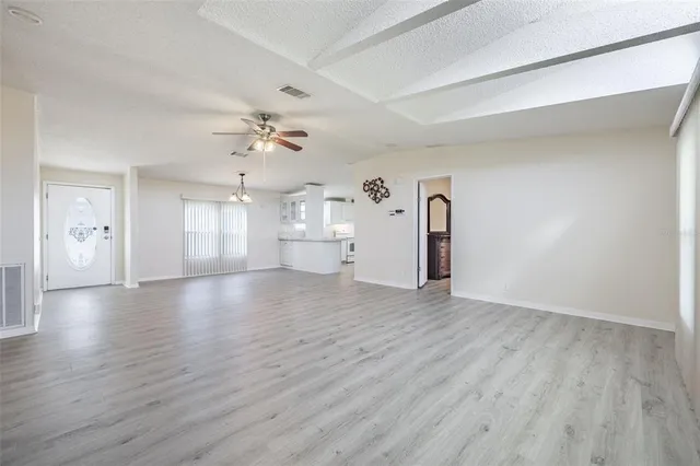 a view of a kitchen with wooden floor and windows