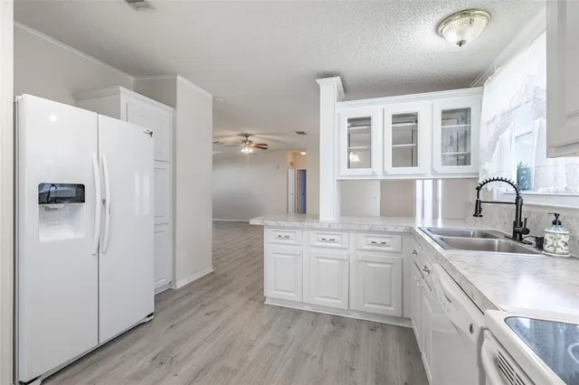 a view of a kitchen with wooden floor and a sink