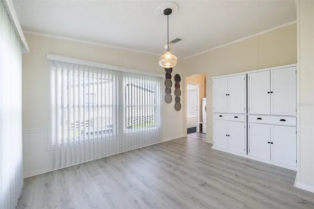 a view of a kitchen with dishwasher and wooden floor