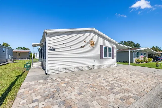 a backyard of a house with table and chairs