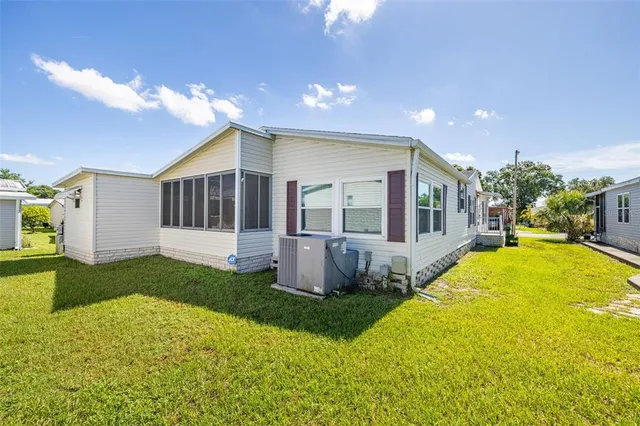 a view of a house with a backyard