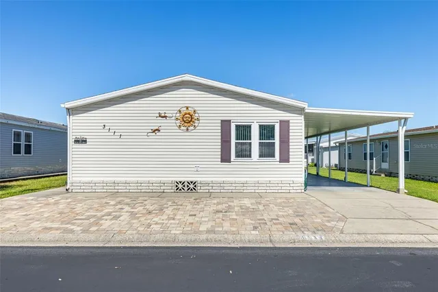 a view of a house with pool and chairs