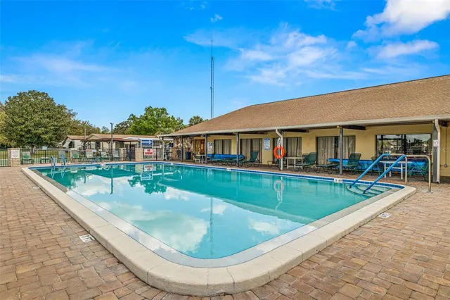 a view of a lake with outdoor seating and city view