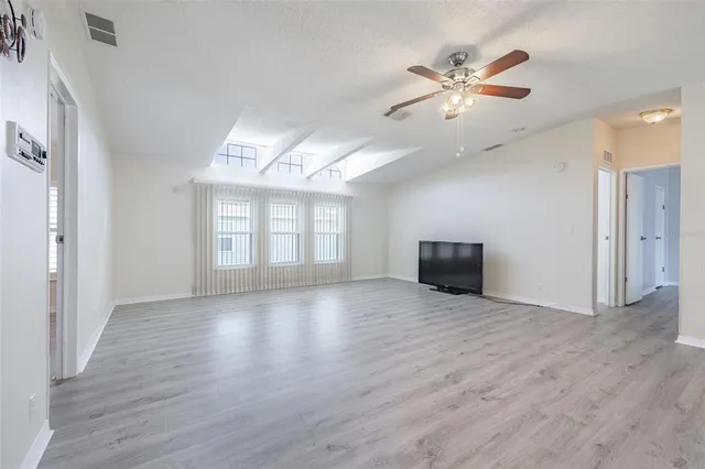 a view of a kitchen and an empty room