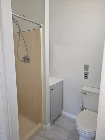 a bathroom with a toilet and a shower