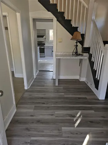 a view of entryway and hall with wooden floor
