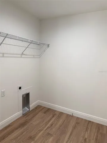 a view of a room with wooden floor and fan