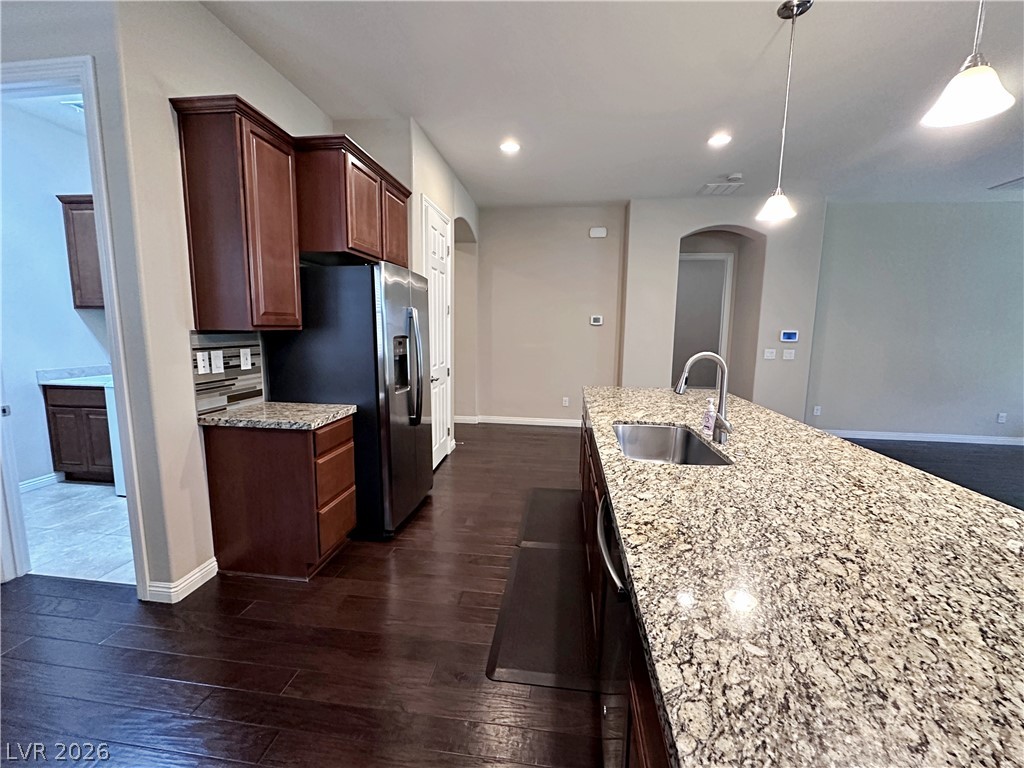 71 Newton Ridge Way Las Vegas, NV 89183 - Photo 17 of 40 A sleek kitchen island provides ample workspace and a focal point for this open-concept culinary space.