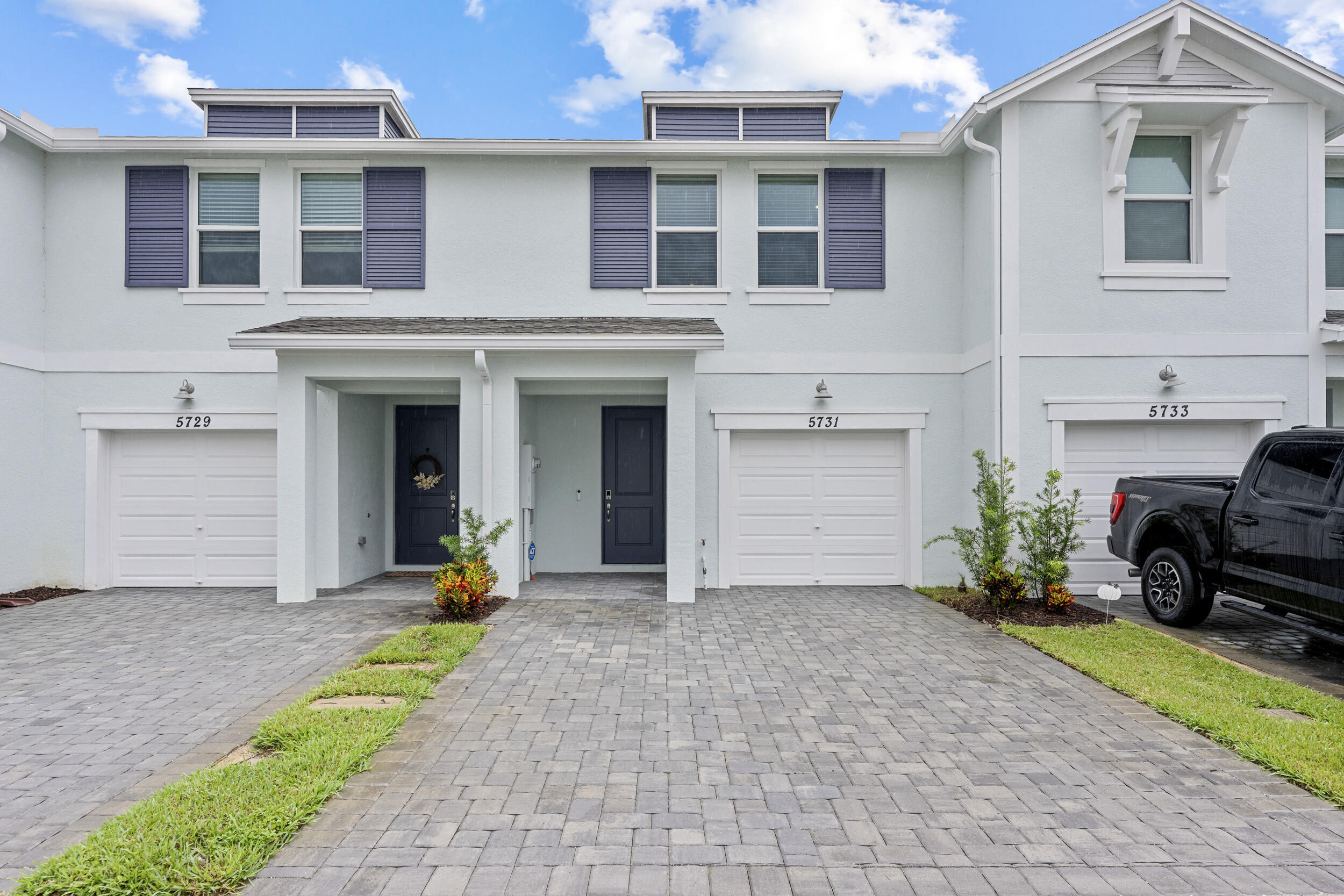 a view of a house with a yard and sitting area