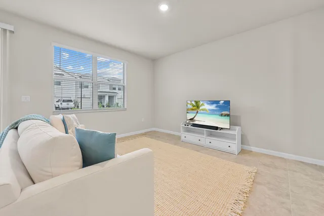 a living room with furniture window and a flat screen tv
