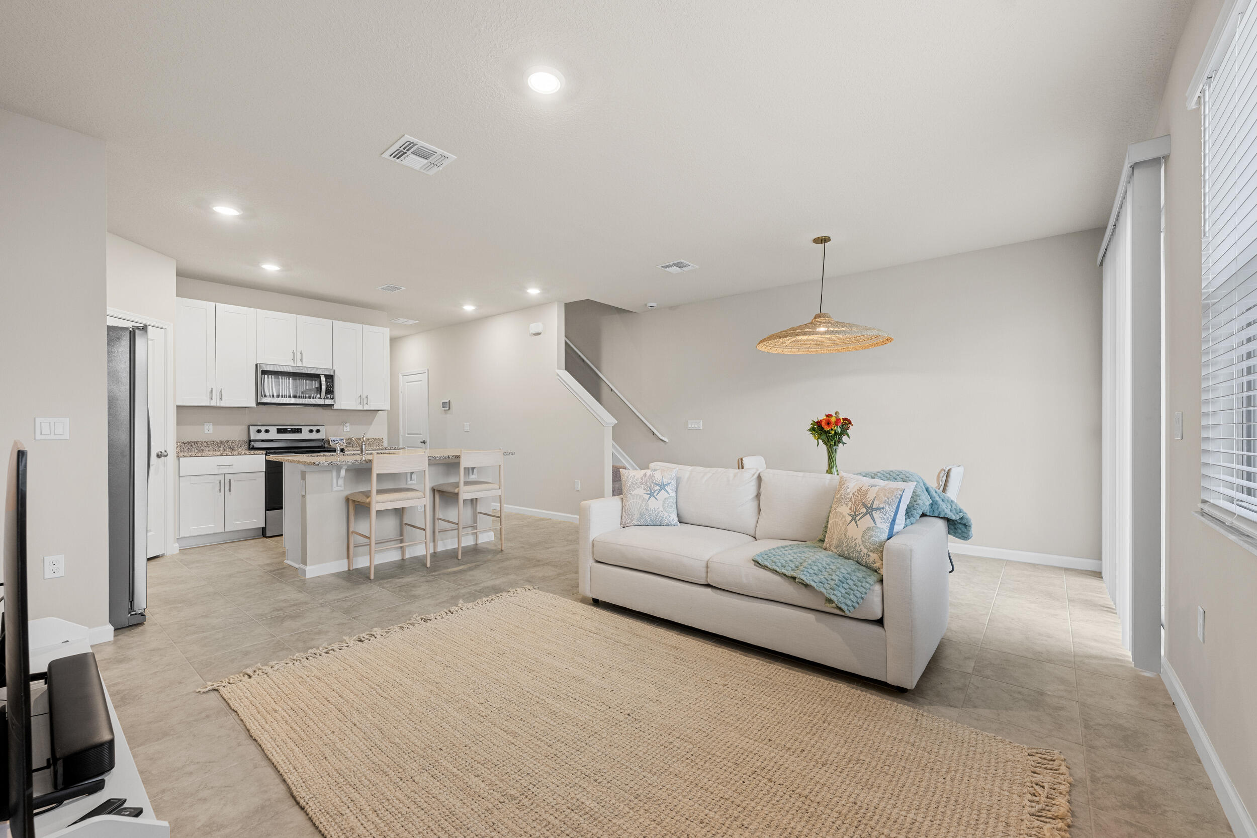 5731 Southeast Edgewater Circle Stuart, FL 34997 - Photo 15 of 42 a living room with furniture and kitchen view