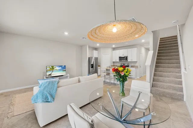 a living room with furniture and flowers