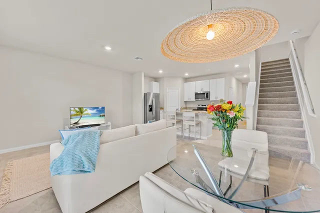 a living room with furniture and flowers