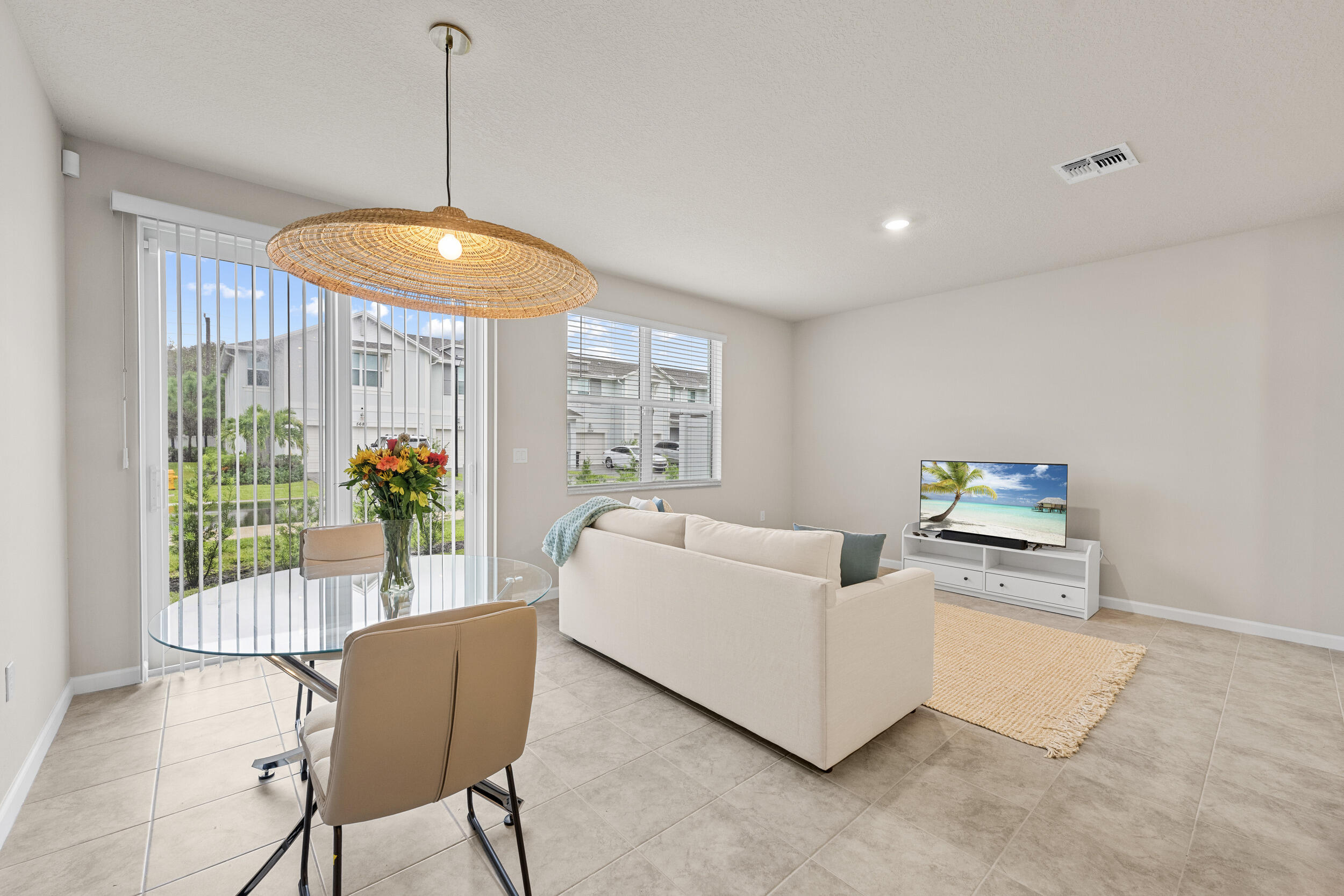 5731 Southeast Edgewater Circle Stuart, FL 34997 - Photo 19 of 42 a living room with furniture and a chandelier