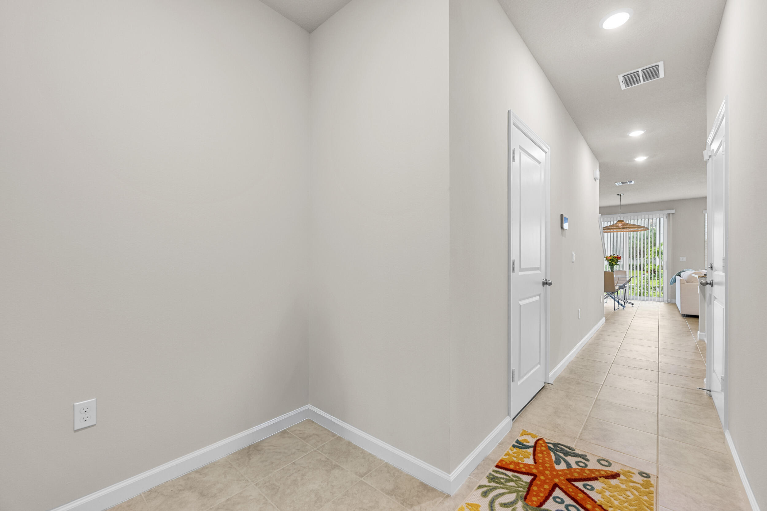 5731 Southeast Edgewater Circle Stuart, FL 34997 - Photo 2 of 42 a view of a hallway with wooden floor