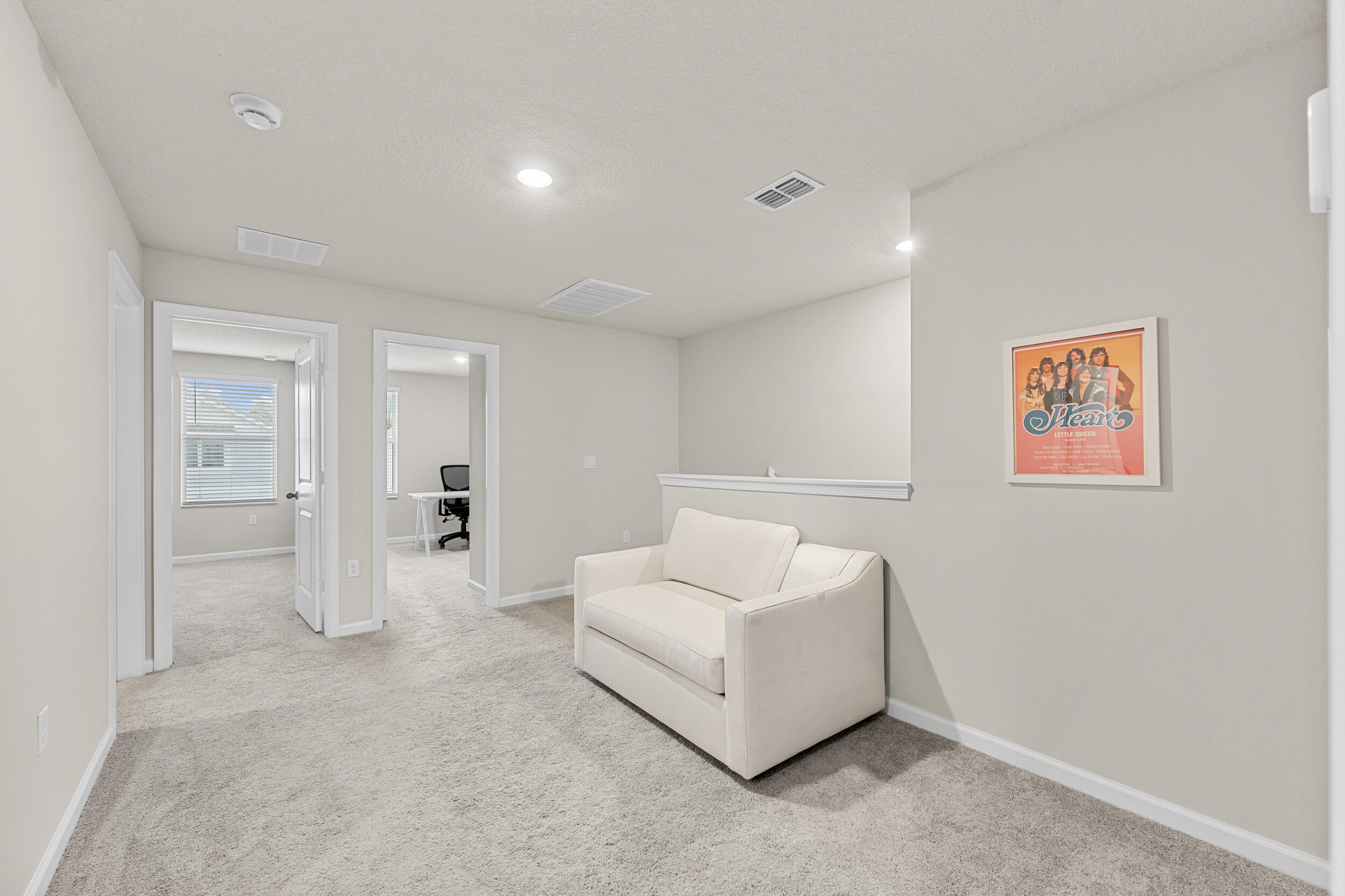 5731 Southeast Edgewater Circle Stuart, FL 34997 - Photo 22 of 42 a spacious bedroom with a bed and a couch