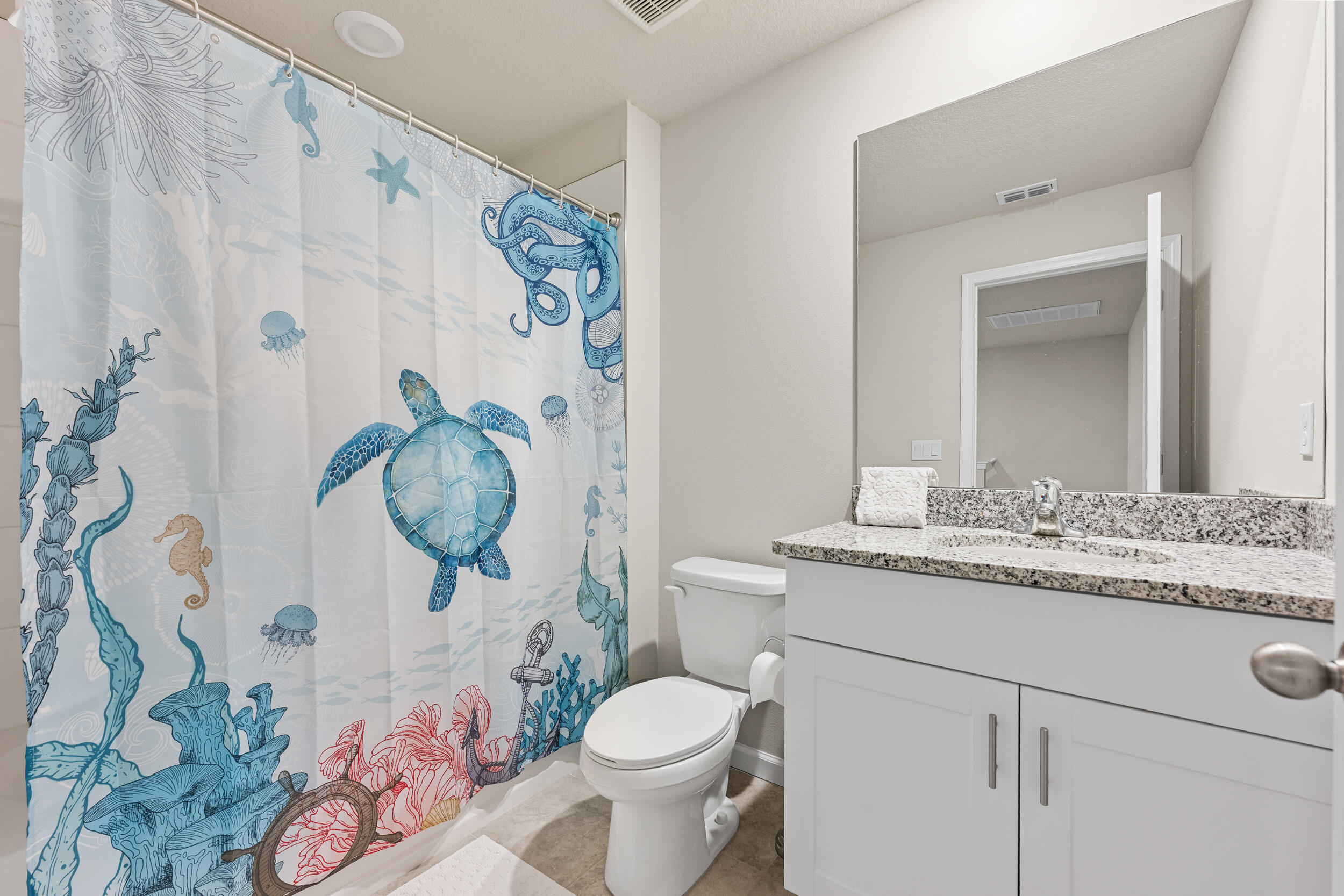 5731 Southeast Edgewater Circle Stuart, FL 34997 - Photo 28 of 42 a bathroom with a granite countertop toilet and a sink