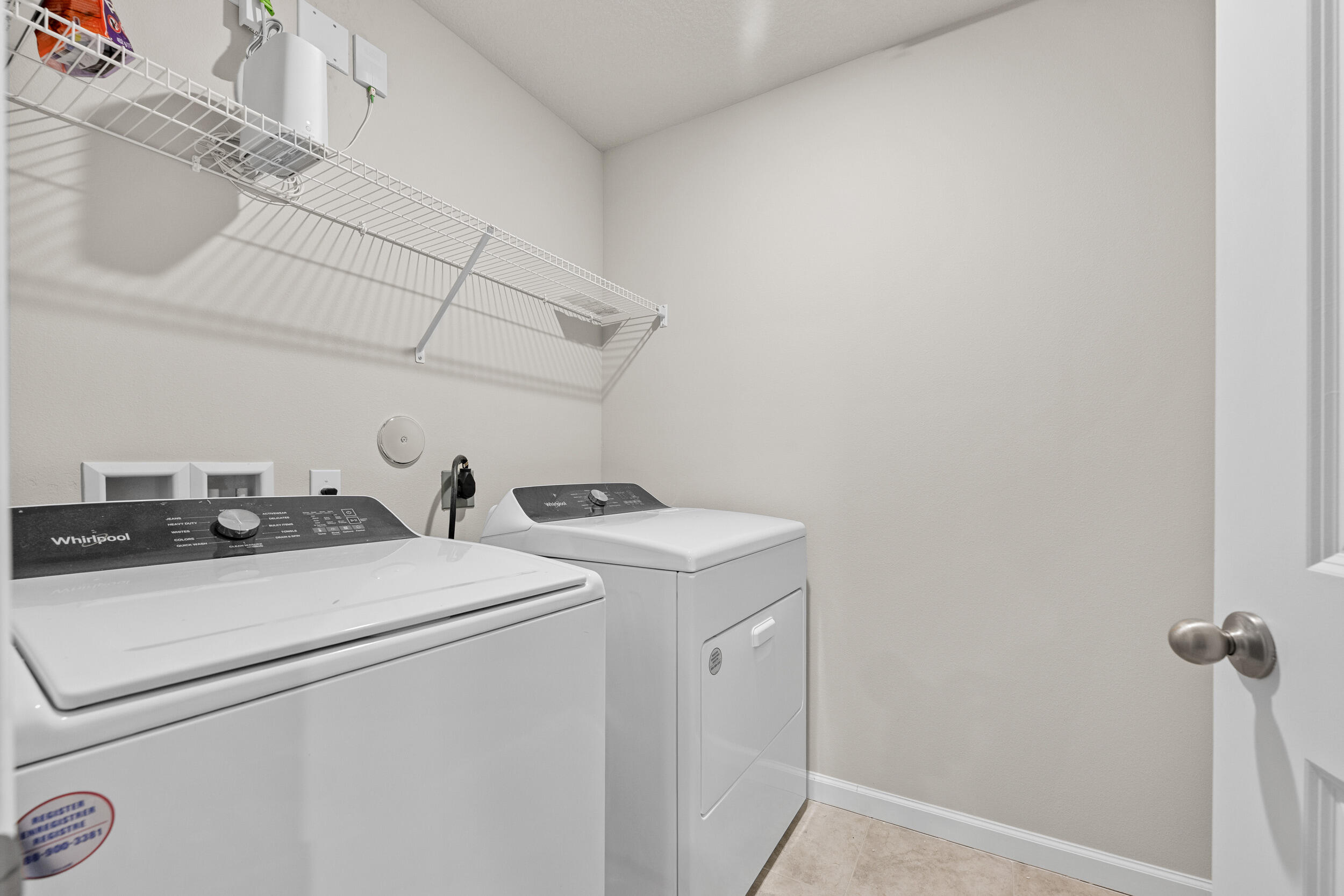 5731 Southeast Edgewater Circle Stuart, FL 34997 - Photo 30 of 42 a utility room with dryer and washer