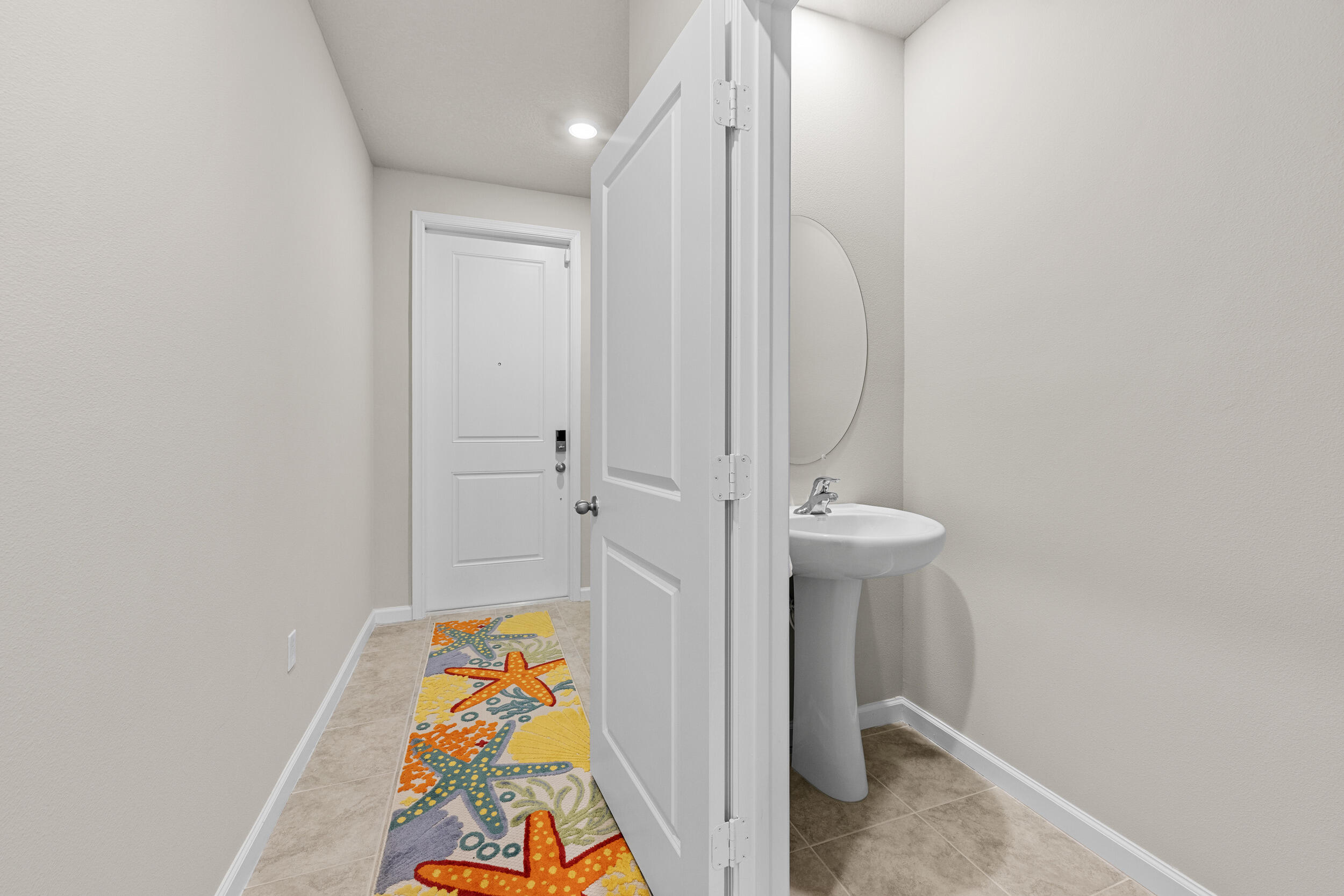 5731 Southeast Edgewater Circle Stuart, FL 34997 - Photo 3 of 42 a bathroom with a sink and a mirror