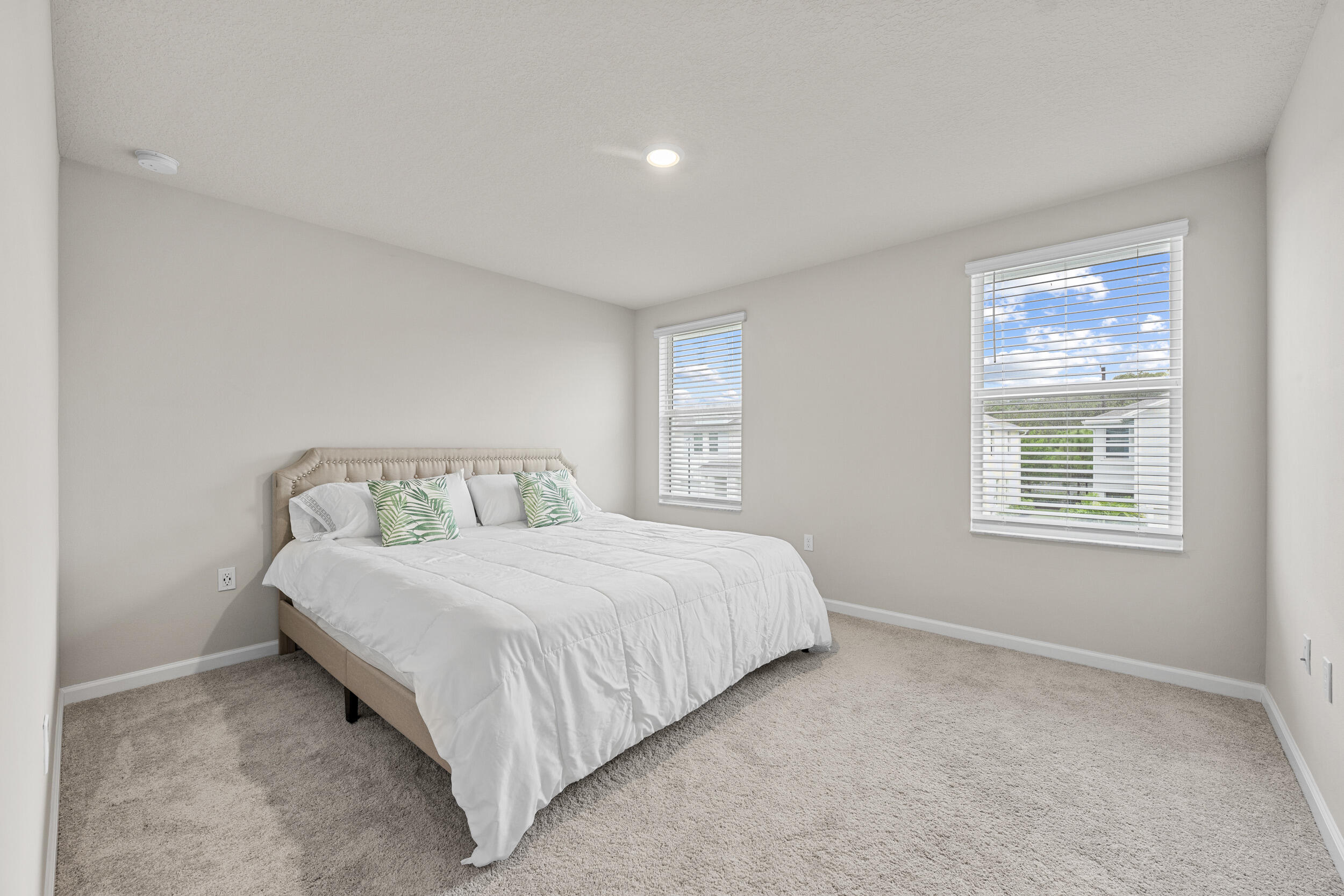 5731 Southeast Edgewater Circle Stuart, FL 34997 - Photo 31 of 42 a spacious bedroom with a bed and a window