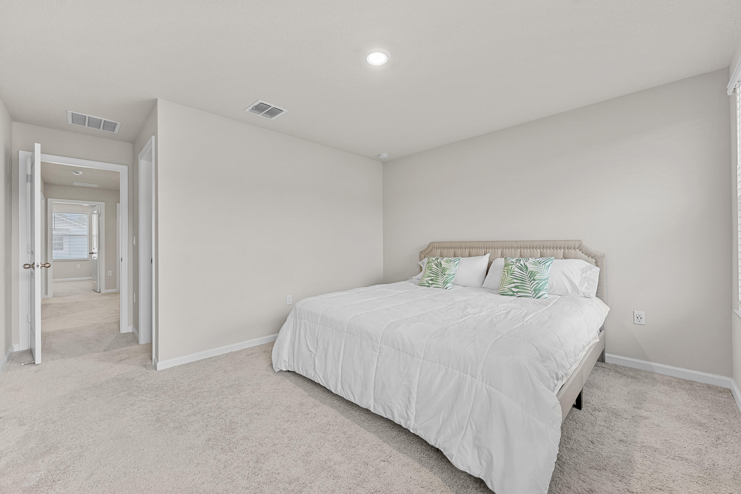 5731 Southeast Edgewater Circle Stuart, FL 34997 - Photo 32 of 42 a bedroom with a bed and painting on the wall