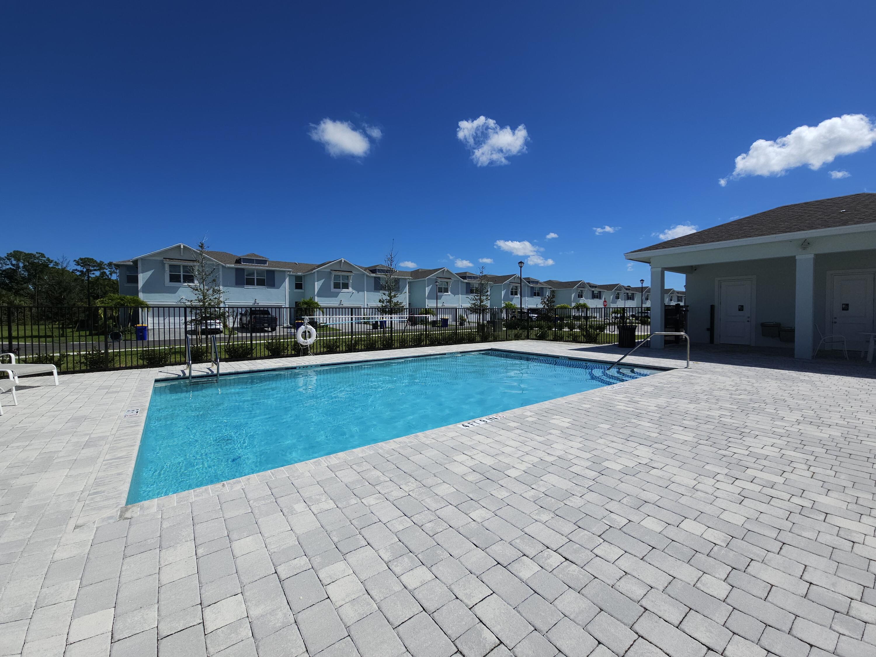 5731 Southeast Edgewater Circle Stuart, FL 34997 - Photo 39 of 42 a view of a swimming pool and a yard
