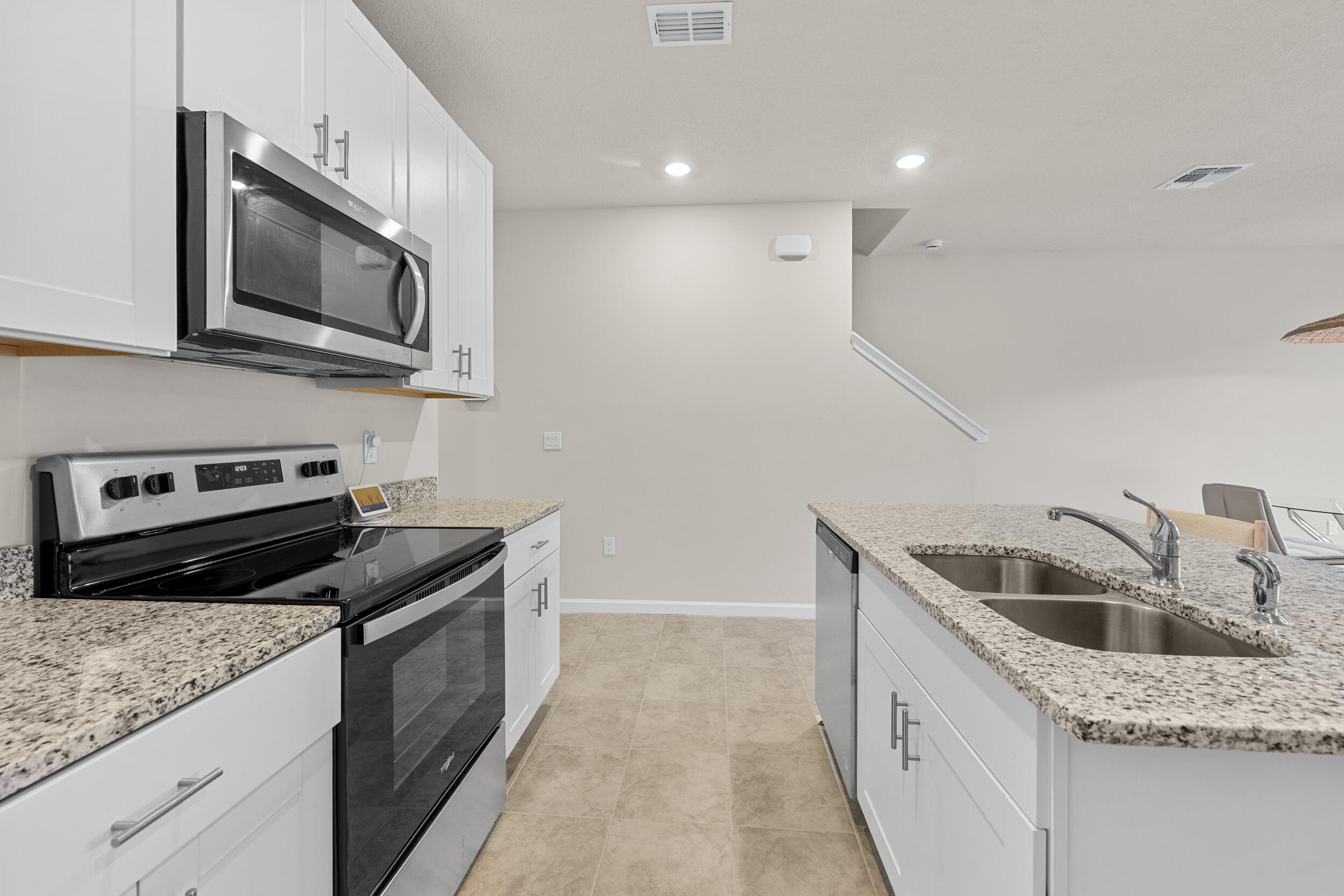 5731 Southeast Edgewater Circle Stuart, FL 34997 - Photo 9 of 42 a kitchen that has a sink and a stove
