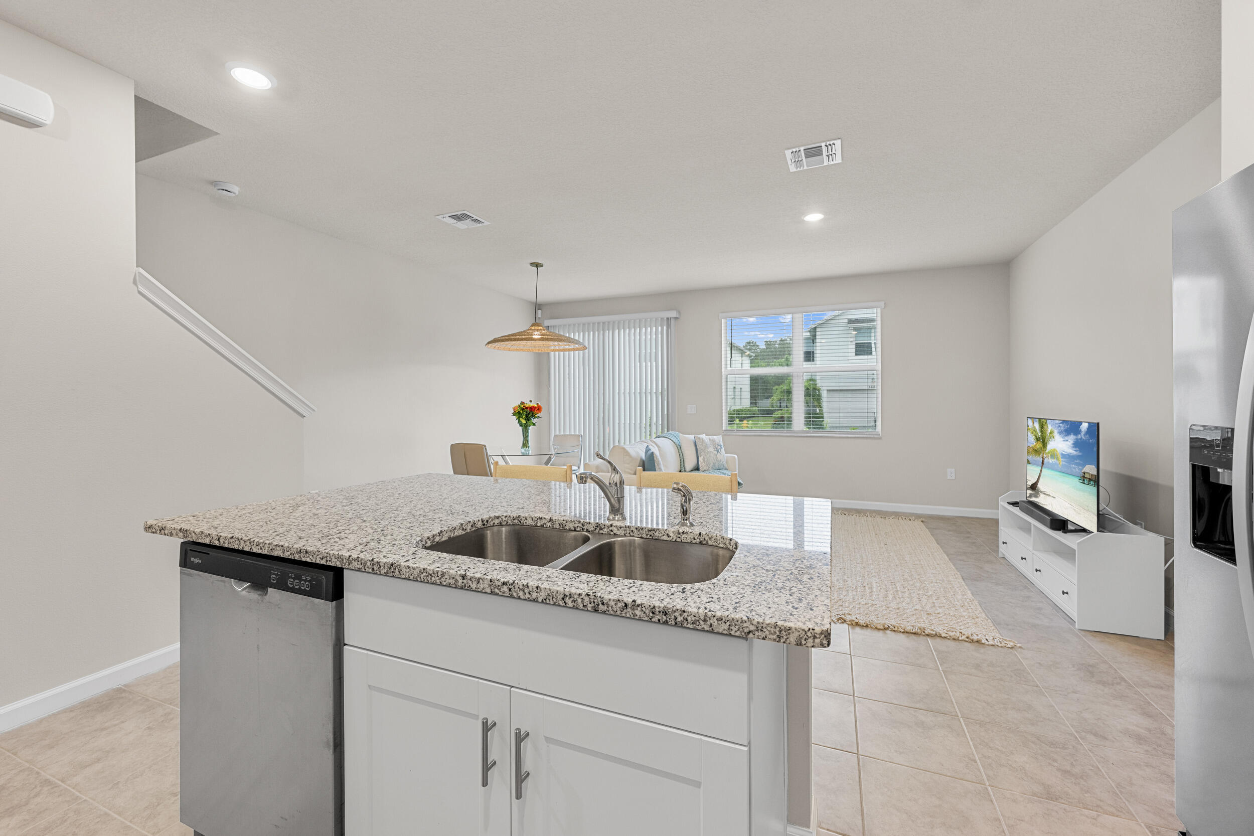 5731 Southeast Edgewater Circle Stuart, FL 34997 - Photo 10 of 42 a kitchen with granite countertop a sink and white cabinets
