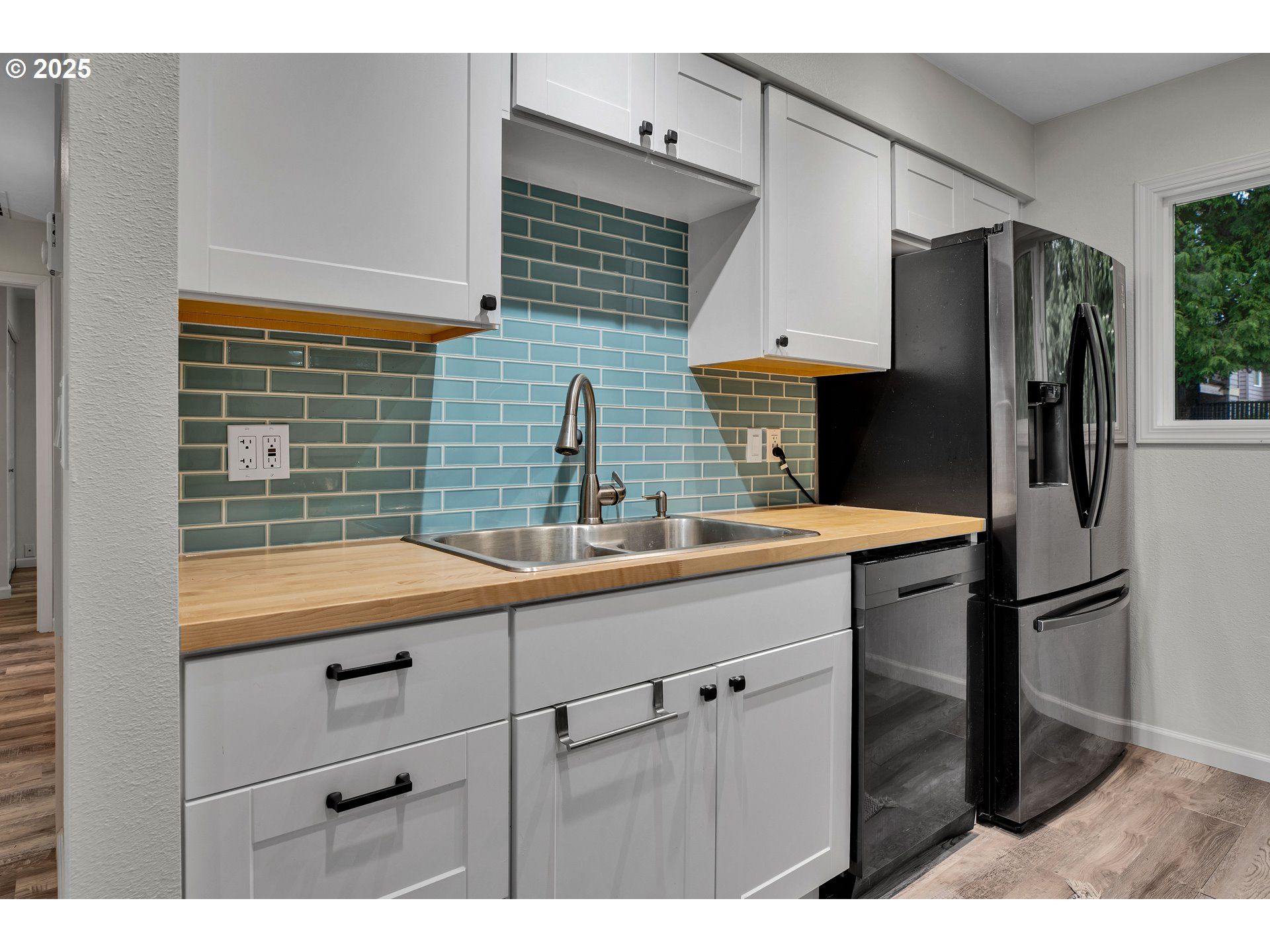 700 Southeast Hogan Road Gresham, OR 97080 - Photo 12 of 37 a kitchen with stainless steel appliances a sink cabinets and a refrigerator