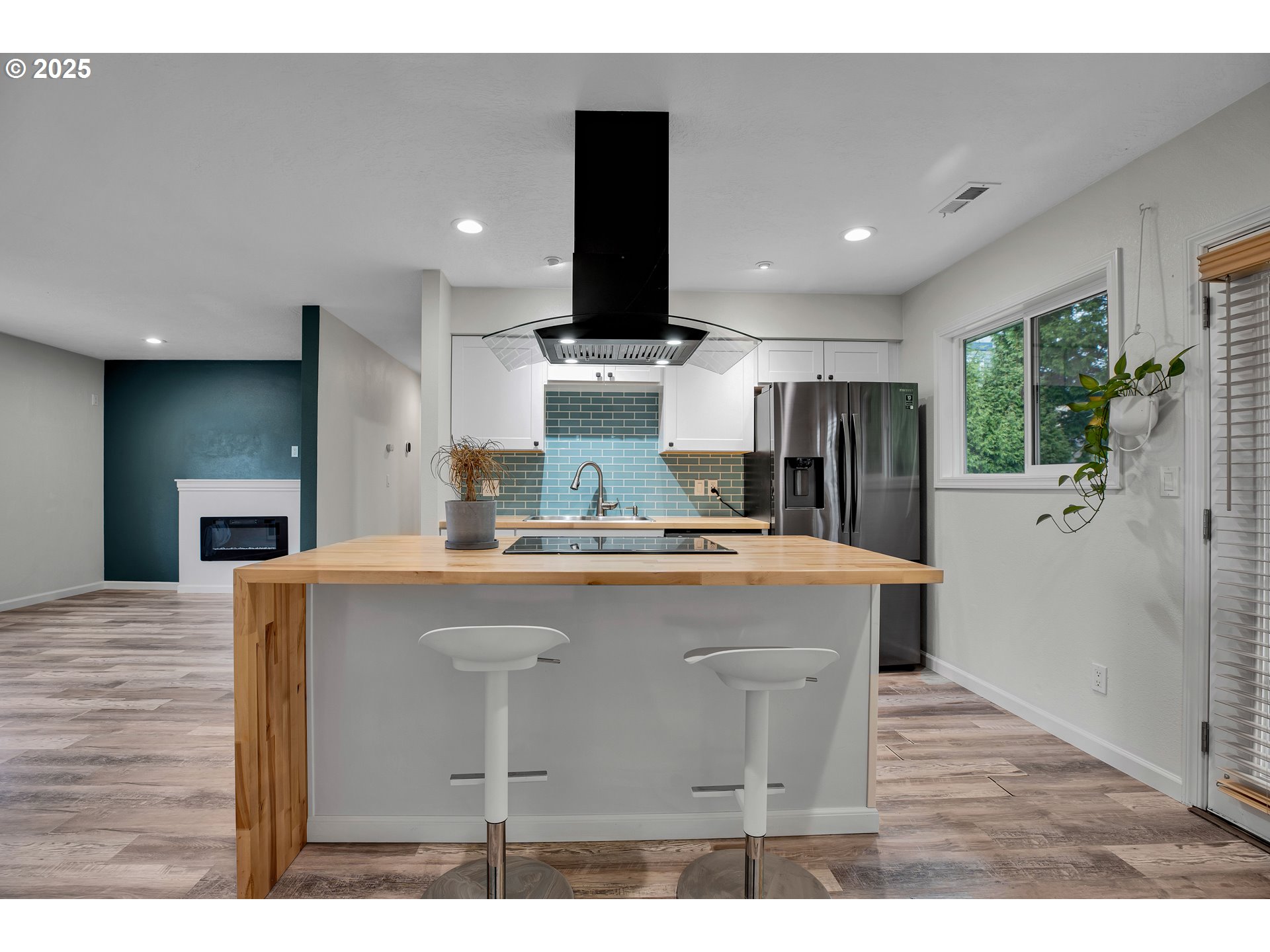 700 Southeast Hogan Road Gresham, OR 97080 - Photo 15 of 37 a view of kitchen with kitchen island stainless steel appliances a sink counter space and wooden floor