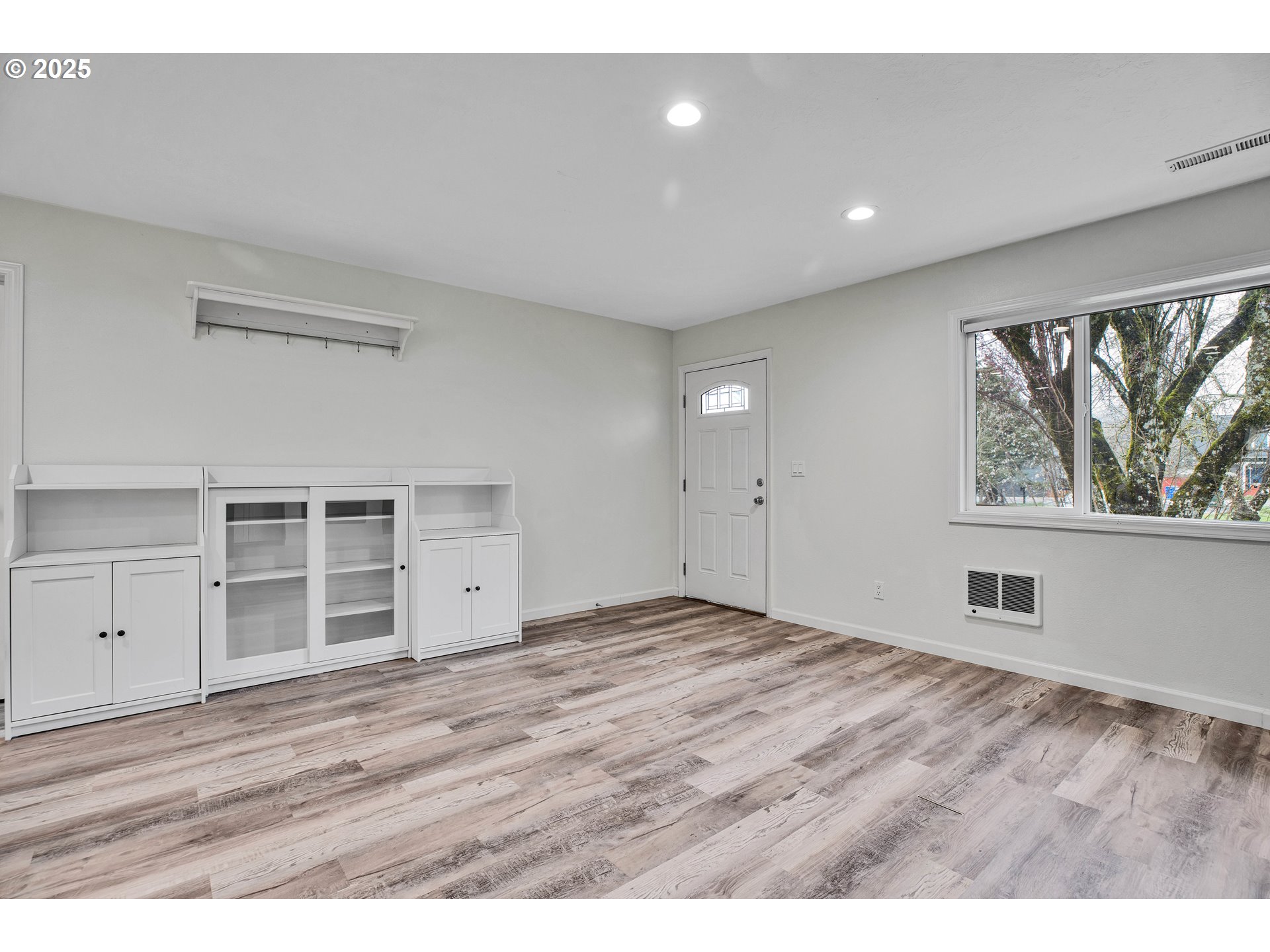 700 Southeast Hogan Road Gresham, OR 97080 - Photo 8 of 37 a view of empty room with wooden floor and window