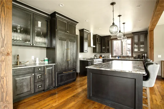a kitchen with stainless steel appliances granite countertop a sink a stove and a refrigerator