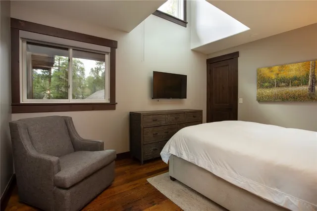 a bedroom with a bed couch and window