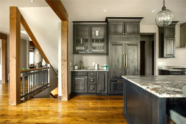 a kitchen with stainless steel appliances granite countertop a sink and a stove