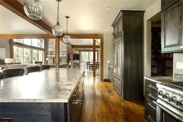 a dining hall with stainless steel appliances granite countertop a stove and refrigerator