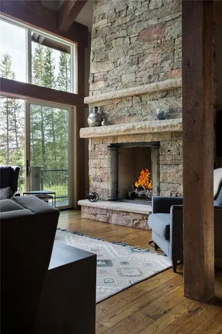 a living room with fireplace furniture and a large window