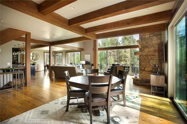 a dining room with furniture a chandelier and wooden floor