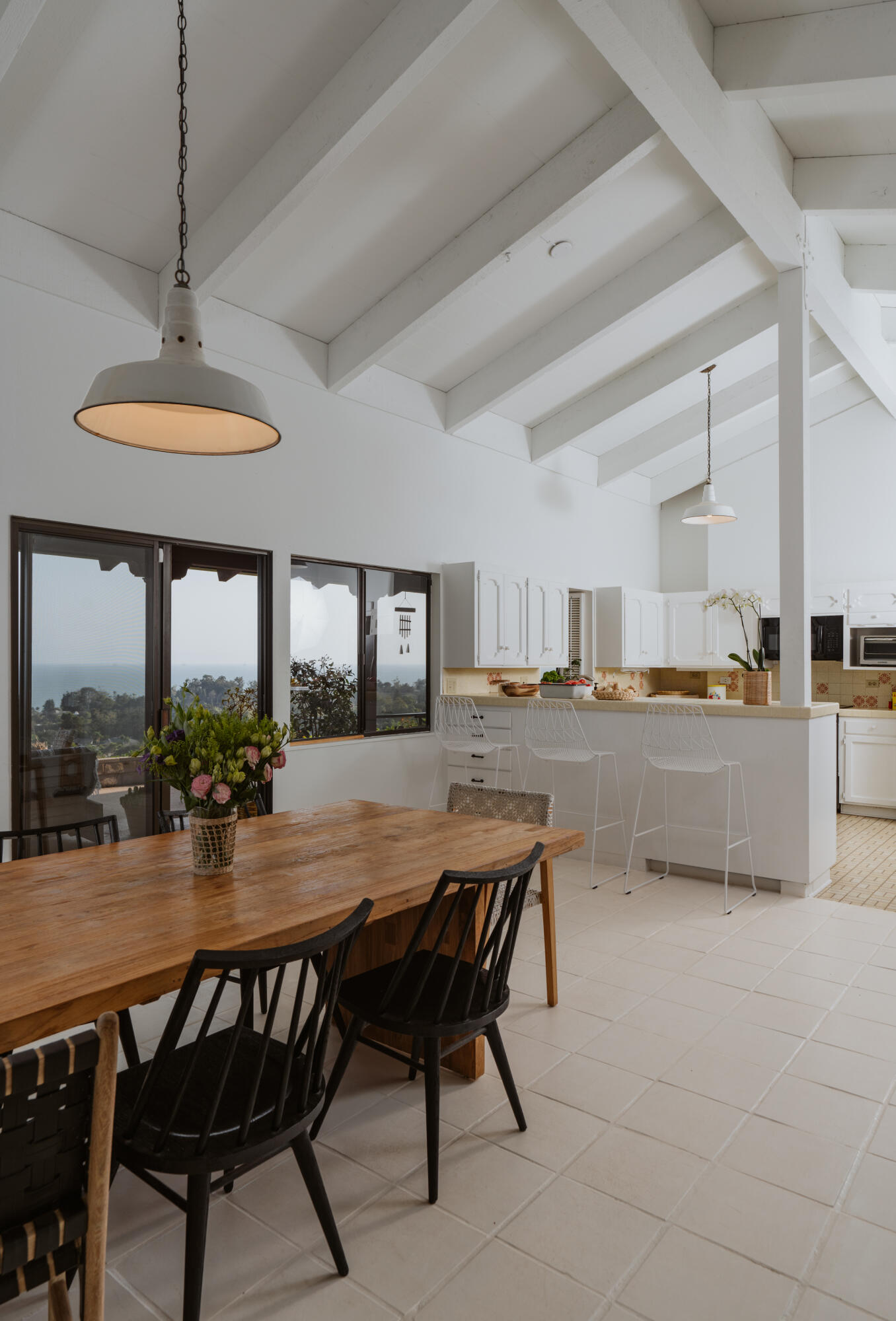 3330 Foothill Road Carpinteria, CA 93013 - Photo 19 of 56 a dining room with furniture a chandelier and kitchen view