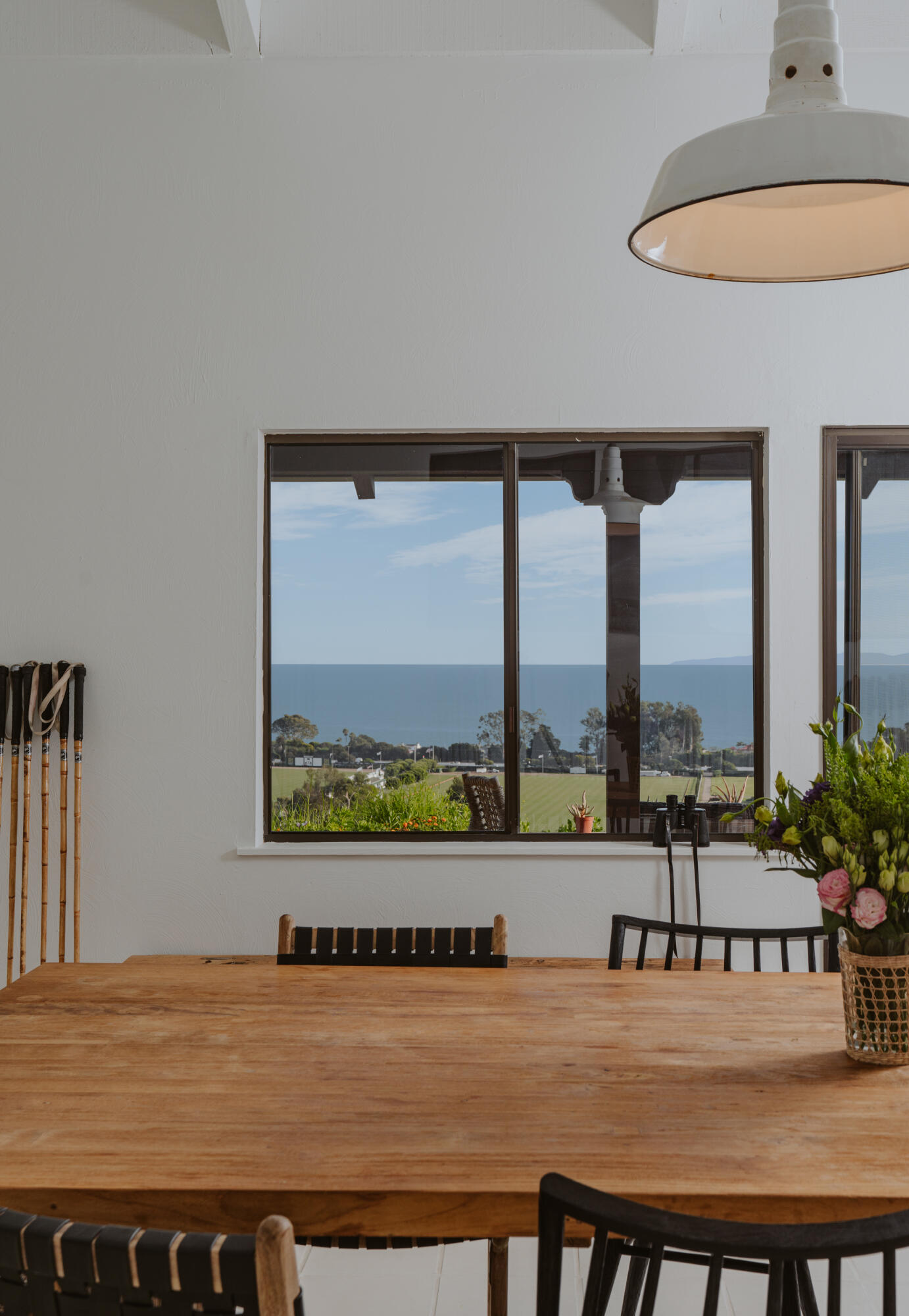 3330 Foothill Road Carpinteria, CA 93013 - Photo 20 of 56 a living room with a table and a floor to ceiling window