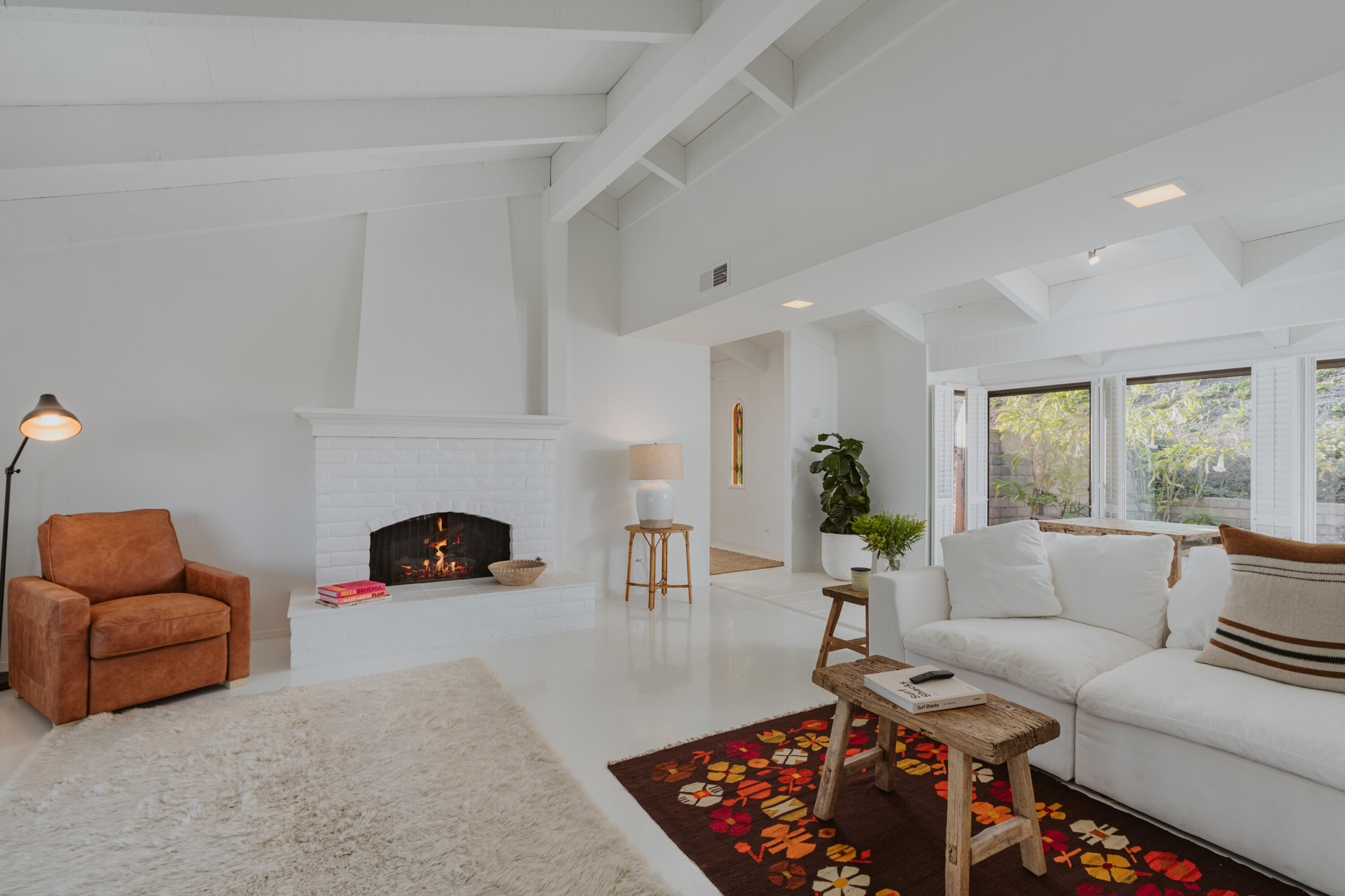 3330 Foothill Road Carpinteria, CA 93013 - Photo 21 of 56 a living room with furniture a rug and a fireplace