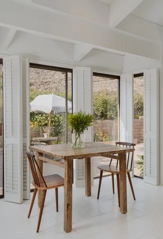 a bedroom with furniture and large windows
