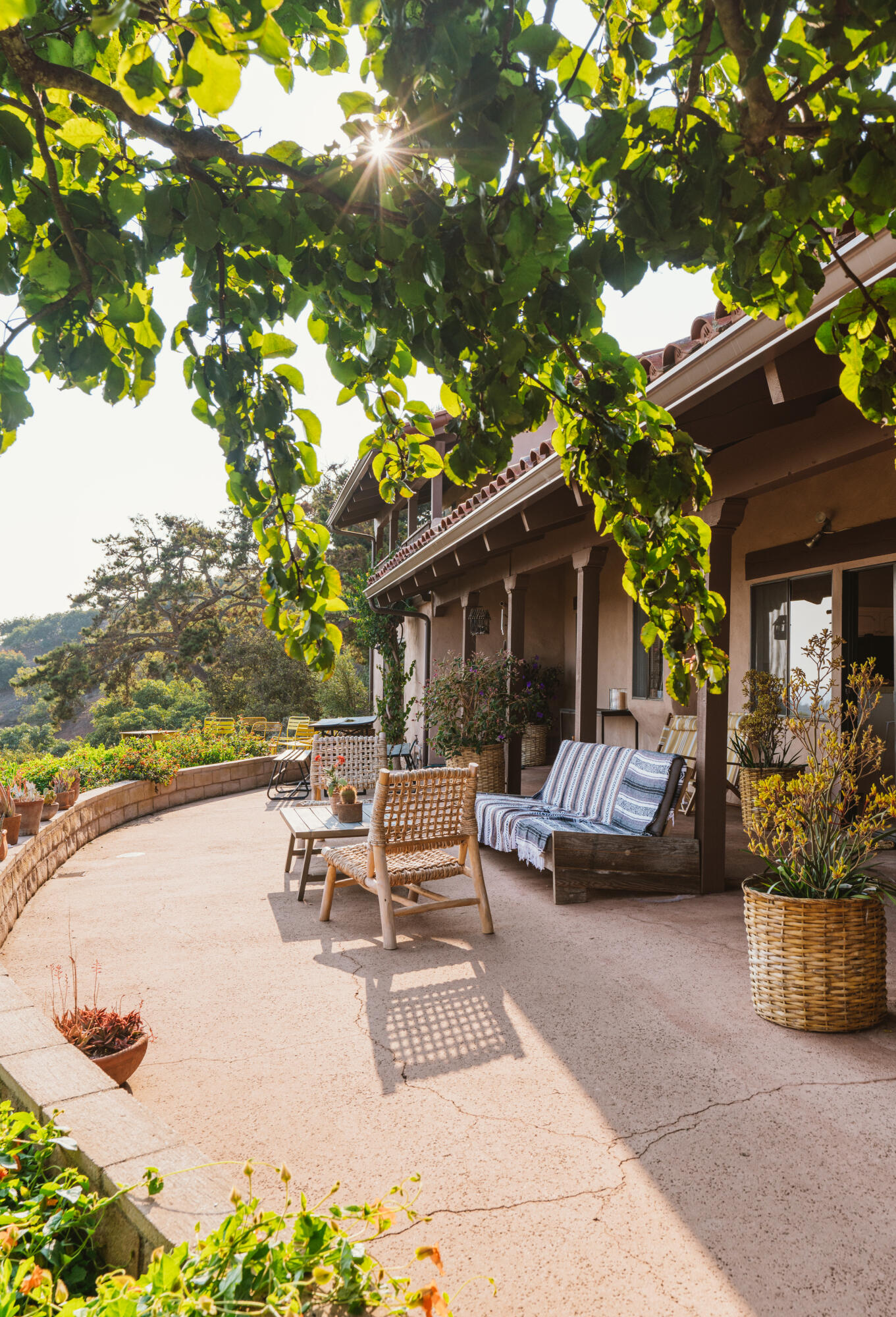3330 Foothill Road Carpinteria, CA 93013 - Photo 6 of 56 a view of a patio with couches and table and chairs under an umbrella