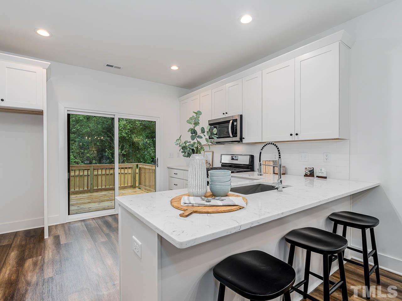 614 East Ellerbee Street Durham, NC 27704 - Photo 15 of 28 a kitchen with sink a stove and microwave