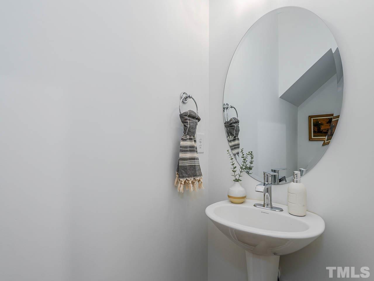 614 East Ellerbee Street Durham, NC 27704 - Photo 16 of 28 a bathroom with a sink and a mirror