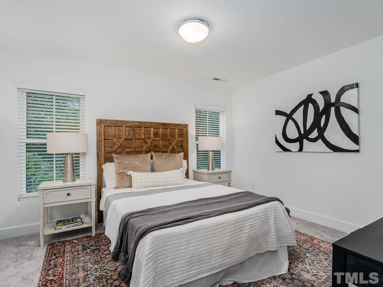 614 East Ellerbee Street Durham, NC 27704 - Photo 17 of 28 a bedroom with a bed and a window